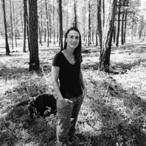 Dr. Prichard standing in a forest in a black and white photo