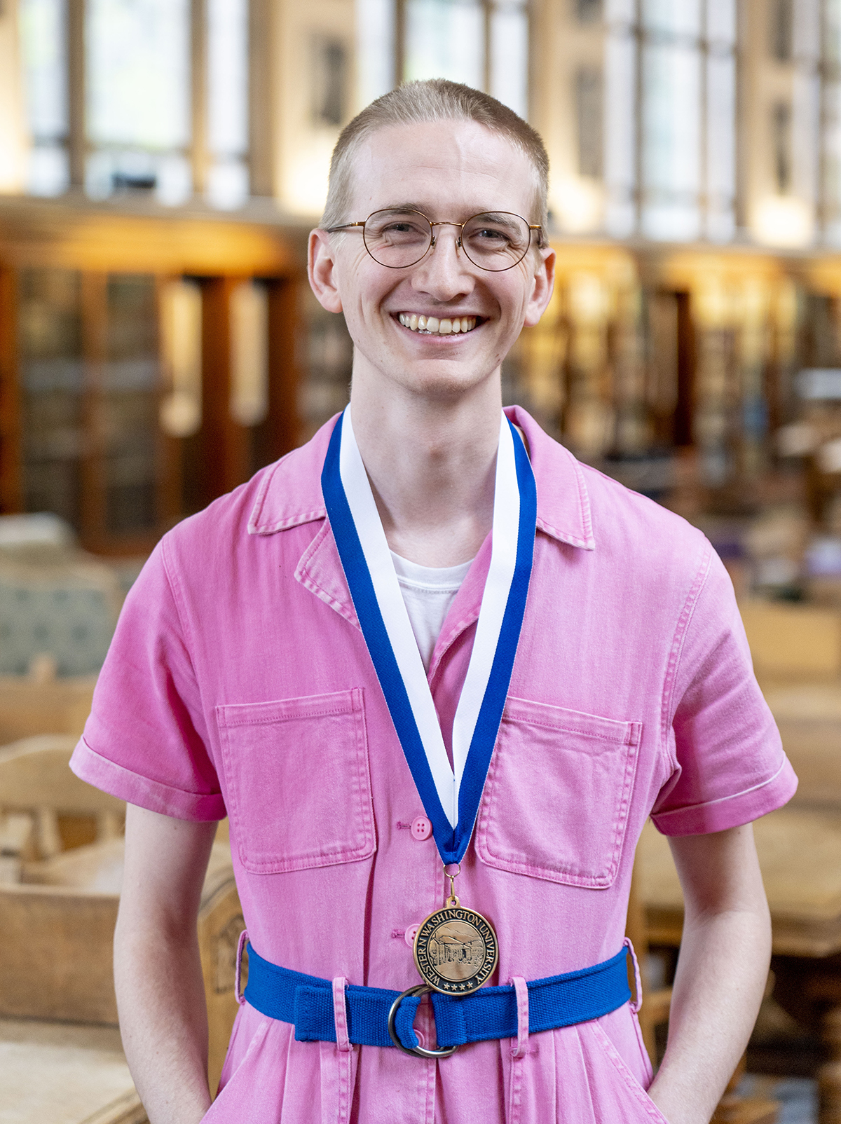 Ian Schaefer Lorenz wearing a Presidential Scholar medal in the library