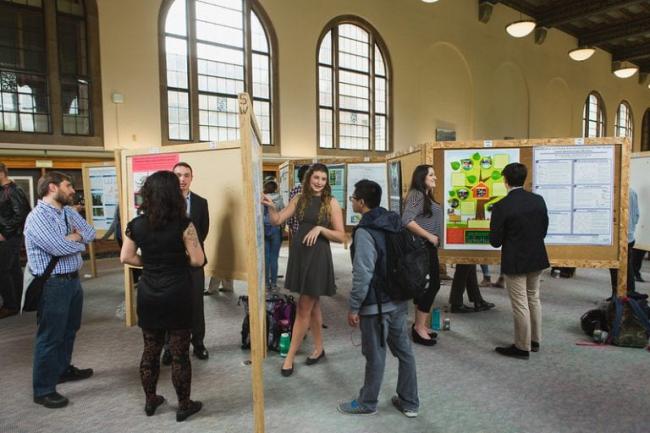 Students discuss their posters at Scholars Week last year
